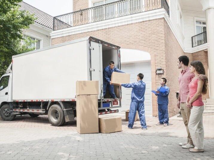 professional movers carrying furniture into a new home in Union Beach, NJ